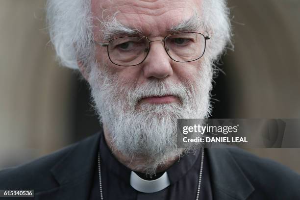 Former Archbishop of Canterbury, Rowan Williams, poses for a photograph after adressing the media, in front of Croydon Minster in Croydon, south...