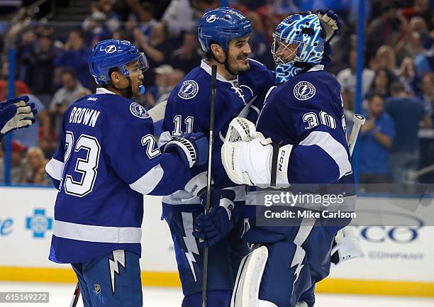 Brown, Brian Boyle and Ben Bishop of the Tampa Bay Lightning celebrate a win over Detroit Red Wings during a game at the Amalie Arena on October 13,...