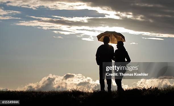 Gartz, Germany In the evening a couple walks under an umbrella during in the National Park Unteres Odertal on October 02, 2016 in Gartz, Germany.