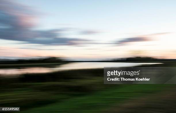 Gartz, Germany The river Oder blurs in a long-term exposure, evening atmosphere in the national park Unteres Odertal on October 02, 2016 in Gartz,...