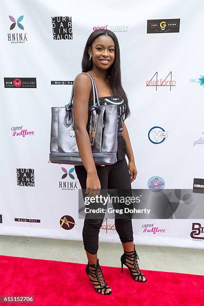 Actress Coco Jones poses for a picture with a Brilliant Freedom Tote Bag at the Breaking The Chains Foundation And Glitter Magazine First Annual Fall...