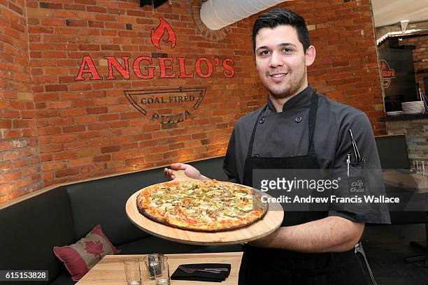 Chef Rick Ruggiero holds a 'Goodfella' pizza at Angelo's Coal Fired Pizza, October 6, 2016. For Now Open column.
