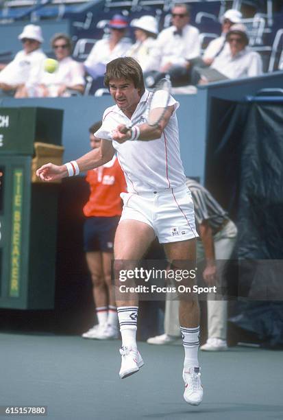 Jimmy Connors of the United States hits a return during a match in the Men's 1983 US Open Tennis Championships circa 1983 at the USTA National Tennis...