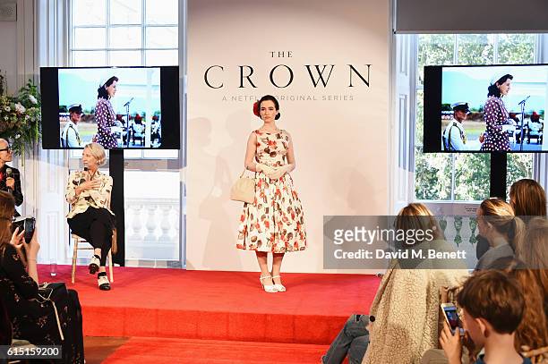 Caryn Franklin and Michele Clapton speak as a model poses at a presentation featuring costumes from new Netflix Original series "The Crown" with...