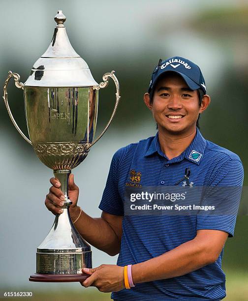 Pavit Tangkamolprasert of Thailand holds the trophy after winning the 2016 Venetian Macao Open at Macau Golf and Country Club on October 16, 2016 in...