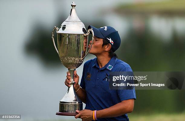 Pavit Tangkamolprasert of Thailand kisses the trophy after winning the 2016 Venetian Macao Open at Macau Golf and Country Club on October 16, 2016 in...