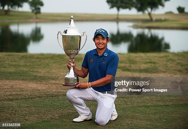 Pavit Tangkamolprasert of Thailand holds the trophy after winning the 2016 Venetian Macao Open at Macau Golf and Country Club on October 16, 2016 in...