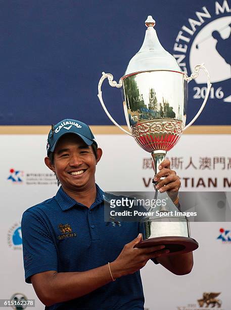 Pavit Tangkamolprasert of Thailand holds the trophy after winning the 2016 Venetian Macao Open at Macau Golf and Country Club on October 16, 2016 in...