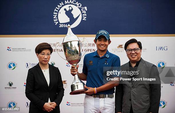 Pavit Tangkamolprasert of Thailand holds the trophy after winning the 2016 Venetian Macao Open at Macau Golf and Country Club on October 16, 2016 in...