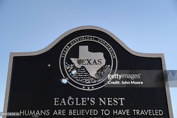 Historic marker, damaged by bullet holes, stands along the Rio Grande on the U.S.-Mexico border on October 16, 2016 in Landry, West Texas. In Texas...