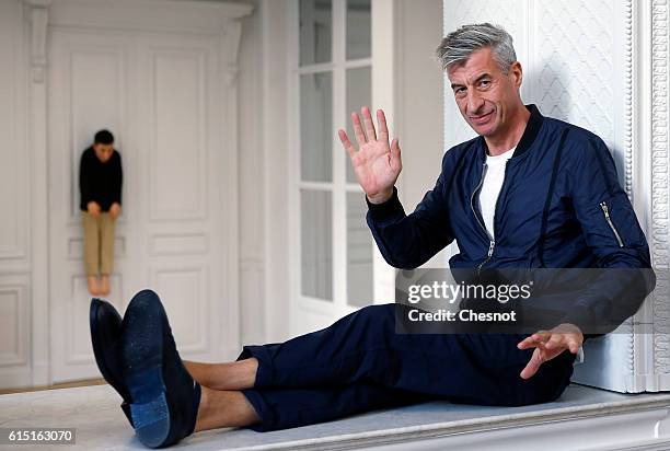 Italian artist Maurizio Cattelan poses next to his artwork "La Rivoluzione Siamo Noi" prior to the opening of the exhibition "Not Afraid of Love" at...