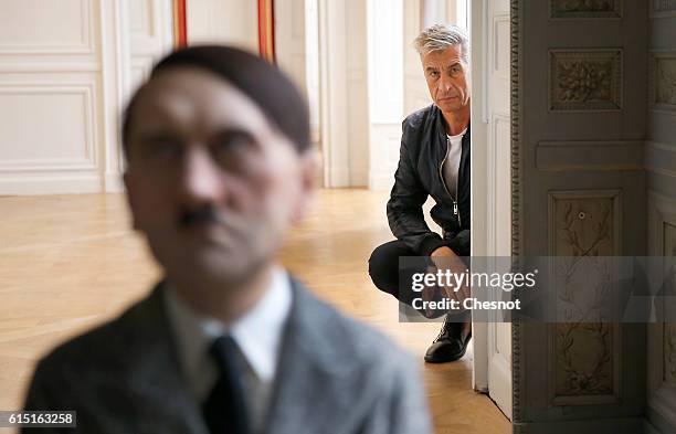 Italian artist Maurizio Cattelan poses next to his artwork 'Him', depicting Hitler on his knees in prayer prior to the opening of the exhibition "Not...