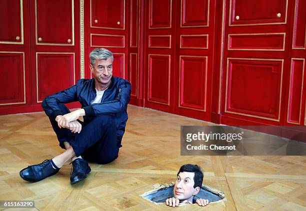 Italian artist Maurizio Cattelan poses next to his artwork "Untitled" prior to the opening of the exhibition "Not Afraid of Love" at the Hotel de la...