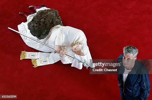 Italian artist Maurizio Cattelan poses next to his artwork "La Nona Ora" prior to the opening of the exhibition "Not Afraid of Love" at the Hotel de...