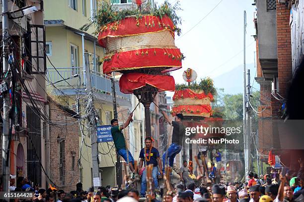 Locals carry as well as rotates top part of a chariot of Lord Narayan across the streets of Hadigaun during Lord Narayan jatra festival in Hadigaun,...