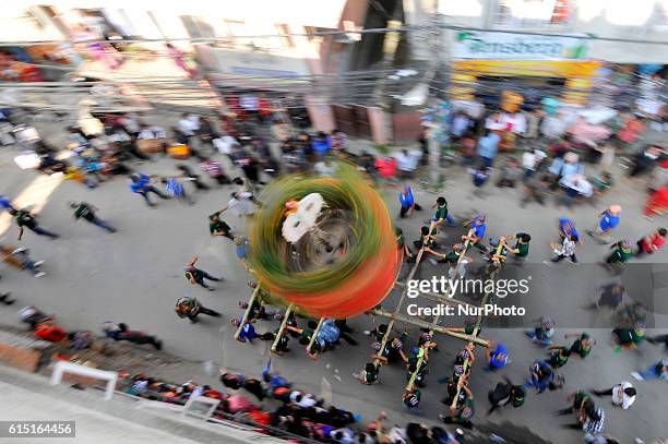 Locals carry as well as rotates top part of a chariot of Lord Narayan across the streets of Hadigaun during Lord Narayan jatra festival in Hadigaun,...