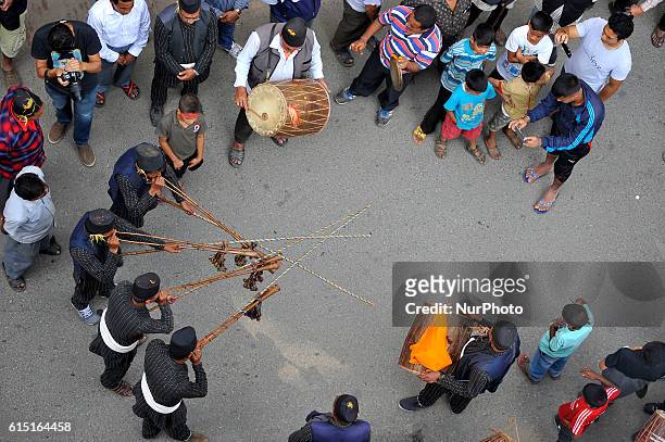 Devotees playing traditional drums as Locals carry and rotates top part of a chariot of Lord Narayan across the streets of Hadigaun during Lord...