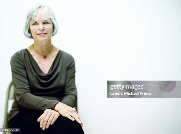 woman sitting on chair - michael sit stock pictures, royalty-free photos & images
