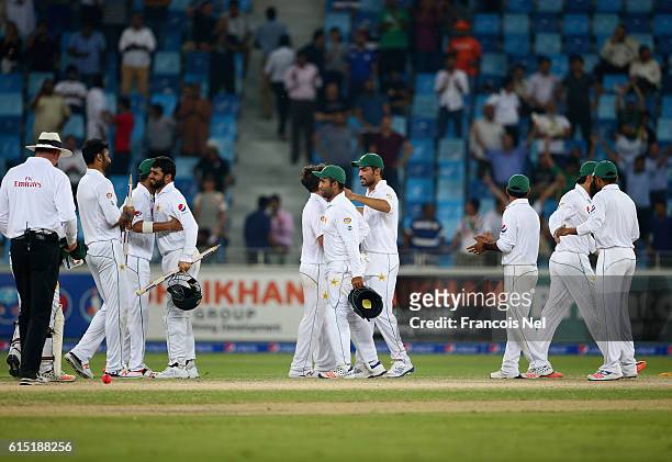 Players of Pakistan celebrates after winning the First Test between Pakistan and West Indies at Dubai International Cricket Ground on October 17,...