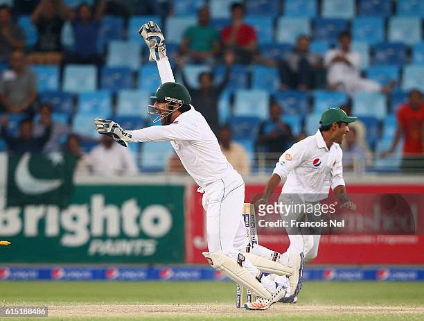 Sarfraz Ahmed of Pakistan celebrates after winning the First Test between Pakistan and West Indies at Dubai International Cricket Ground on October...