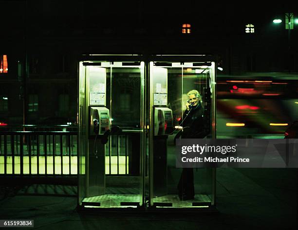 woman in telephone booth - telefonzelle stock-fotos und bilder