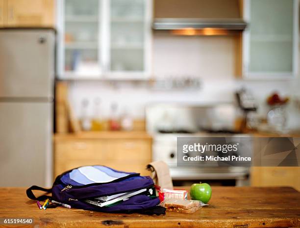 student's backpack and lunch on kitchen counter - kitchen bench stock pictures, royalty-free photos & images