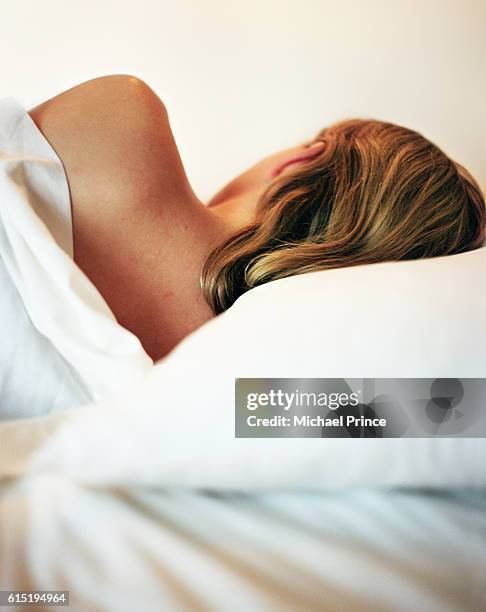 woman sleeping - woman back pillow blonde stock pictures, royalty-free photos & images