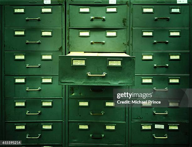 open drawer in file cabinet - folder stock-fotos und bilder