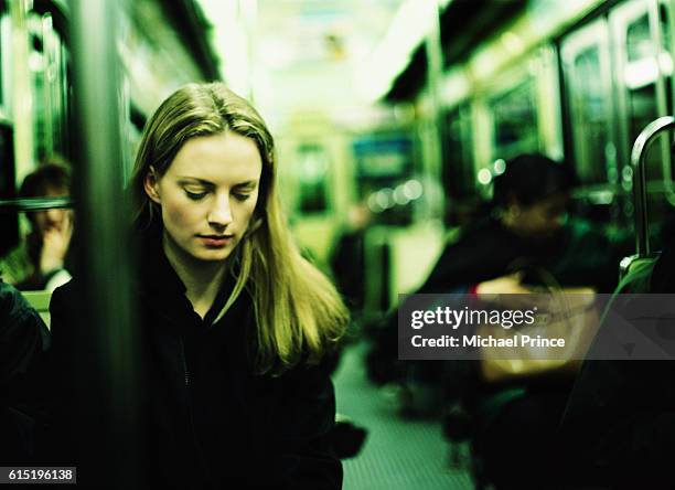 young woman riding subway - tímido imagens e fotografias de stock