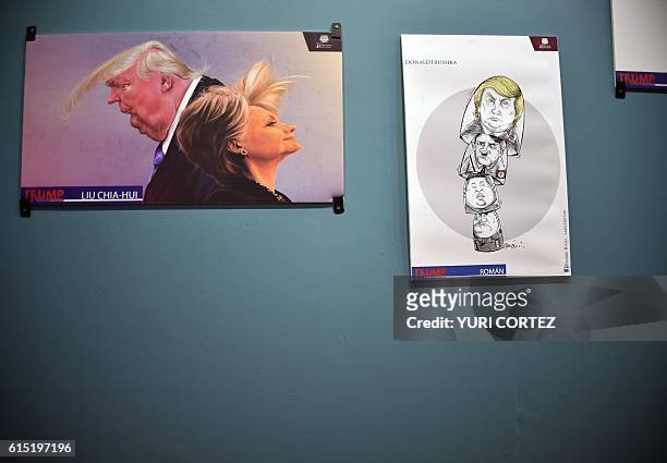 Caricatures depicting US Republican presidential candidate Donald Trump and Democratic presidential nominee Hillary Clinton, are displayed as part of...