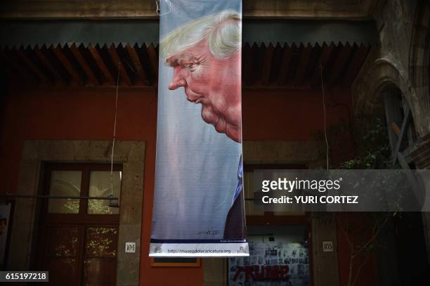 Banner depicting US Republican presidential candidate Donald Trump hangs as part of "A Wall of Caricatures" exhibition at the Caricature Museum in...
