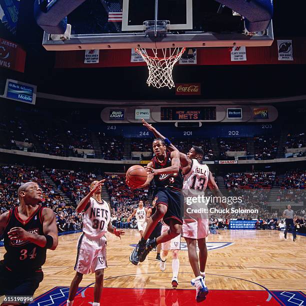 Allen Iverson of the Philadelphia 76ers shoots against Kendall Gill of the New Jersey Nets circa 1998 at the Contintental Airlines Arena in East...