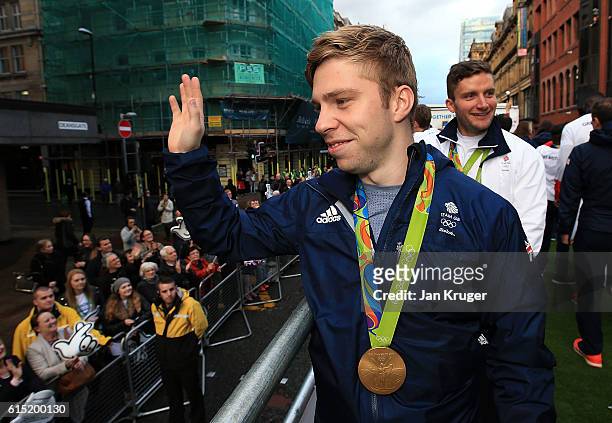 Philip Hindes waves at the crowd during a Rio 2016 Victory Parade for the British Olympic and Paralympic teams on October 17, 2016 in Manchester,...