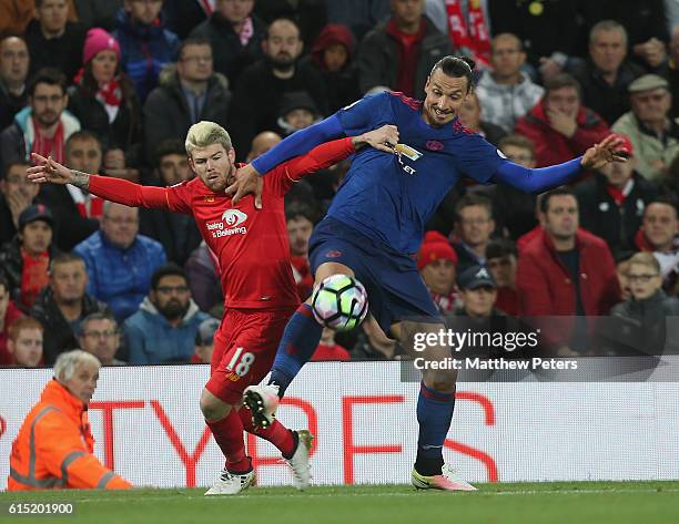 Zlatan Ibrahimovic of Manchester United in action with Alberto Moreno of Liverpool during the Premier League match between Liverpool and Manchester...