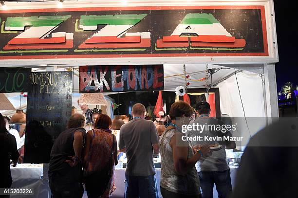 Music fans order pizza during Desert Trip at The Empire Polo Club on October 14, 2016 in Indio, California.