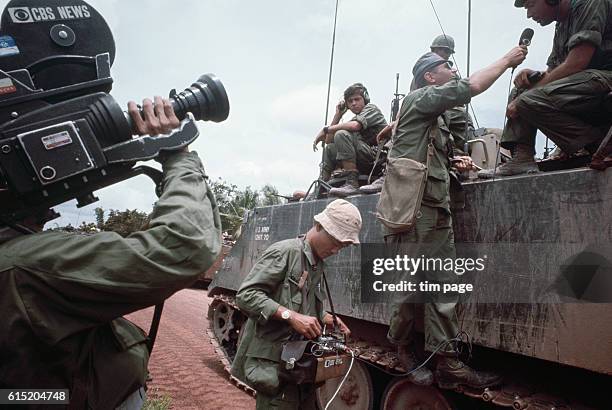 Camera crew interviews American soldiers, Tay Ninh Road, Vietnam. 1967. | Location: Tay Ninh Road, Vietnam.