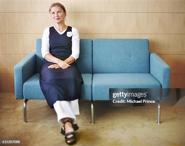 woman sitting on couch - michael sit stock pictures, royalty-free photos & images