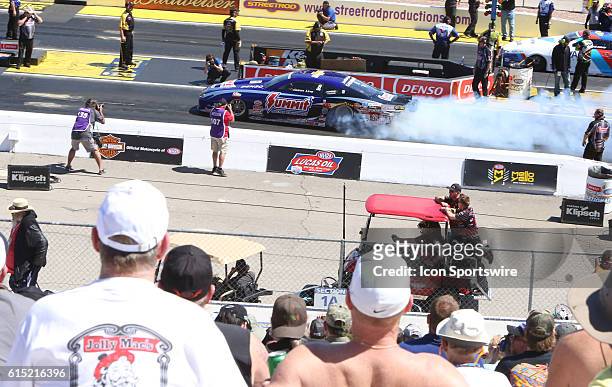 Fans watch the 2016 DENSO Spark Plugs NHRA Nationals Drag Race at Las Vegas Speedway The Strip at Las Vegas Motor Speedway Saturday, April 2, 2015.