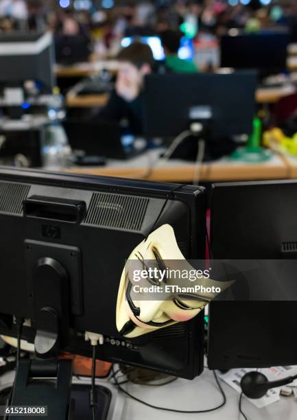 guy fawkes mask hanging off computer screen - anonymous mask stock pictures, royalty-free photos & images