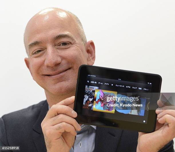 Japan - Amazon.com Inc. Chief executive officer Jeff Bezos holds a Kindle Fire HD in Tokyo on Oct. 24, 2012. The U.S. Online retailer said the same...