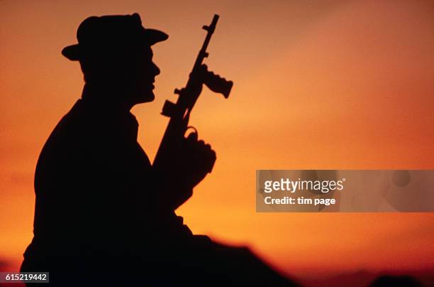 Soldier from the 6th batalion sits on a watch at sunset, Bien Hoa, Vietnam. 1965. | Location: Bein Hoa, Vietnam.