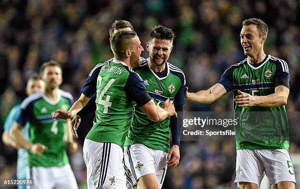 March 2016; Conor Washington, left, Northern Ireland, celebrates with Paddy McNair, Oliver Norwood and Jonny Evans after scoring his side's first...