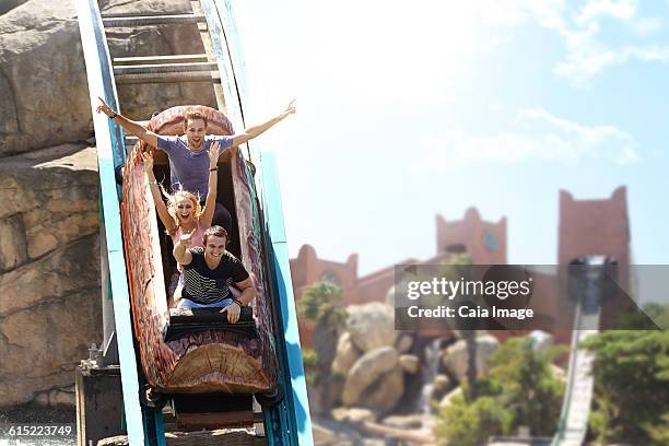 enthusiastic friends cheering and riding log amusement park ride - young woman screaming on a rollercoaster stock pictures, royalty-free photos & images