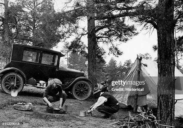 Two men prepare a meal at their campsite in the Cibola National Forest, New Mexico, 1924.