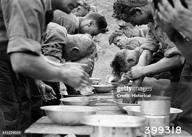 Firefighters wash up after fighting the O'Brien Creek fire. Lolo national Forest, Montana, August 21, 1940.