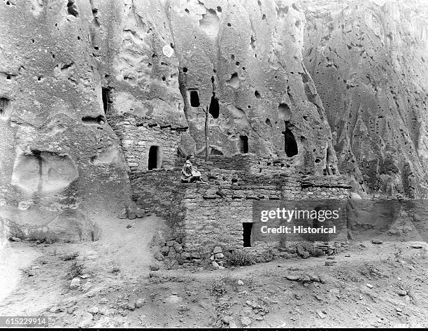 The restored ruins of an old Native American cliff dwelling in Bandelier National Monument. Santa Fe National Forest, New Mexico.