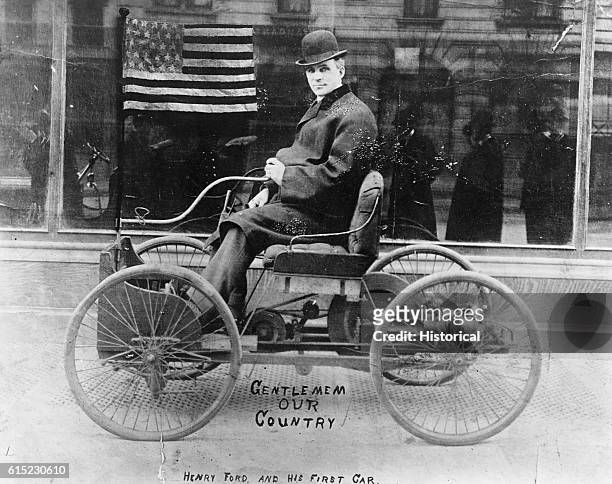 American inventor and industrialist, Henry Ford posing in the driving seat of his first car, the Quadricycle, New York City, 1910. Ford has brought...