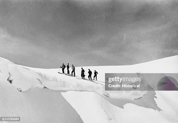 An exploratory party led by Alf Engen, forest officers, and citizens from Twin Falls, stops above a snow cornice on Minidoka's Magic Mountain,...