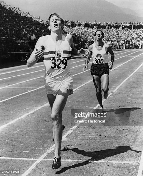 Dr. Roger Bannister hits the tape in the 1954 Miracle Mile race in Vancouver, B.C. The neurologist became the first man to break the four-minute mile...