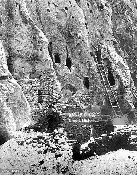 The restored ruins of an old Native American cliff dwelling in Bandelier National Monument. Santa Fe National Forest, New Mexico.